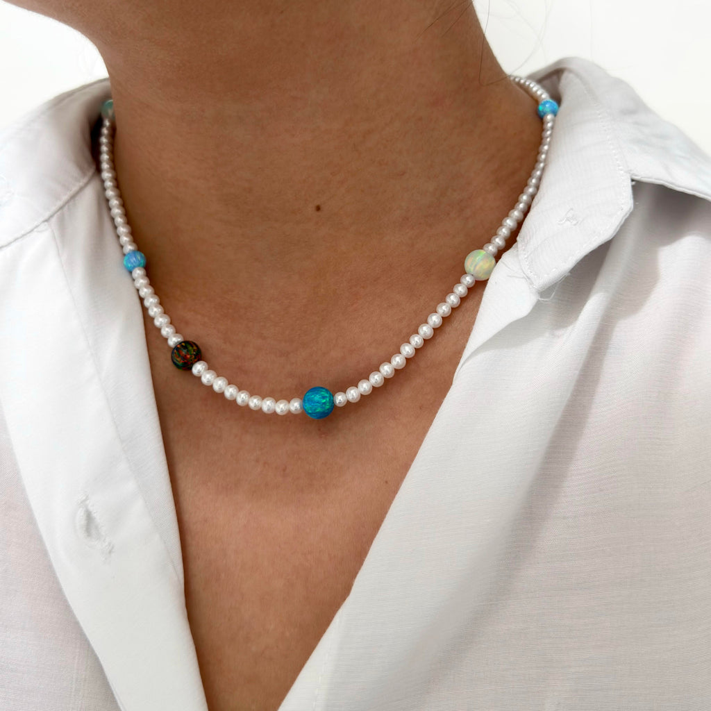 
Model wearing a celestial gemstone and freshwater pearl necklace.