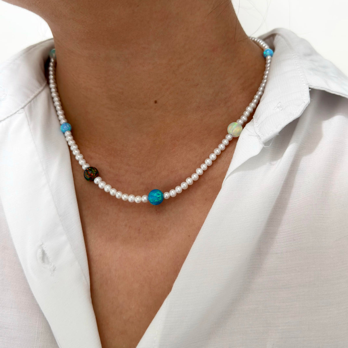 
Model wearing a celestial gemstone and freshwater pearl necklace.
