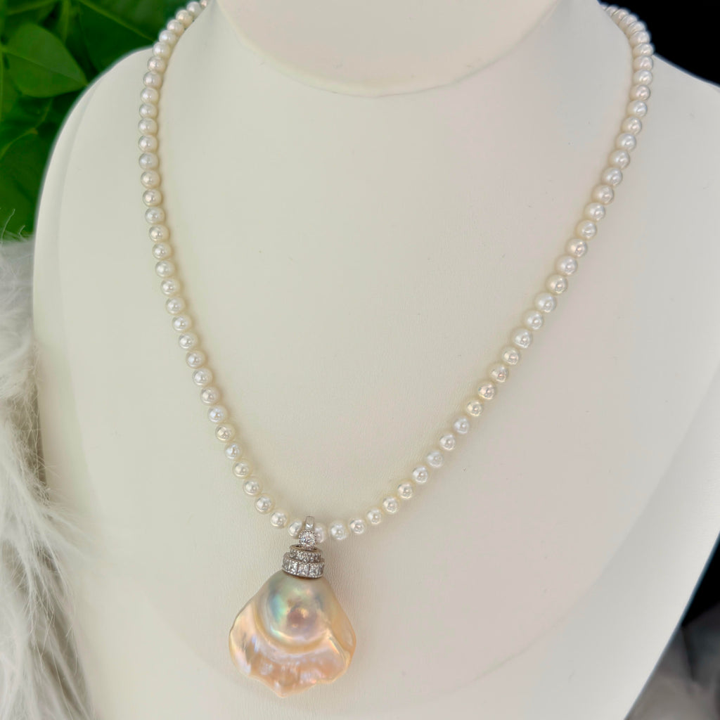Colour-shifting detail on golden-blue baroque freshwater pearl pendant with light golden halo and universal sterling silver bail.