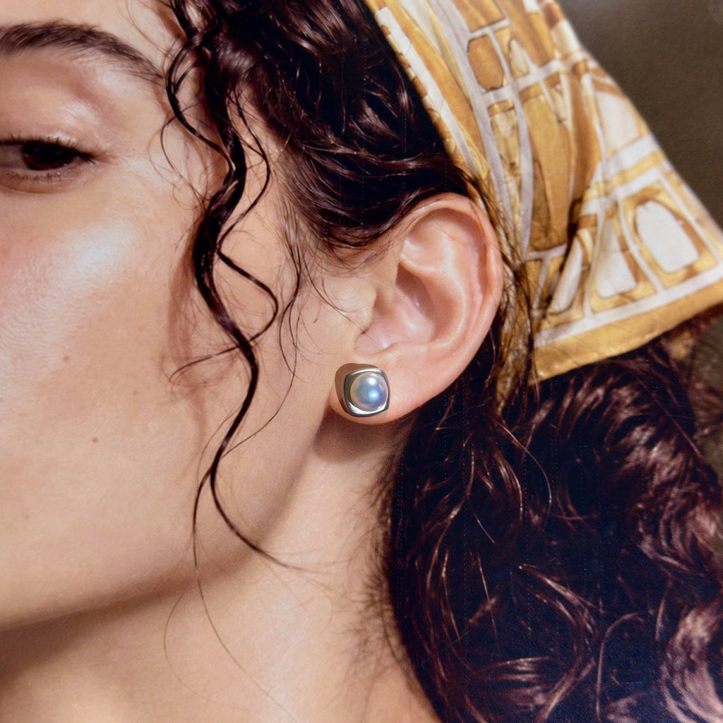Model wearing blue-halo freshwater pearl stud earrings.
