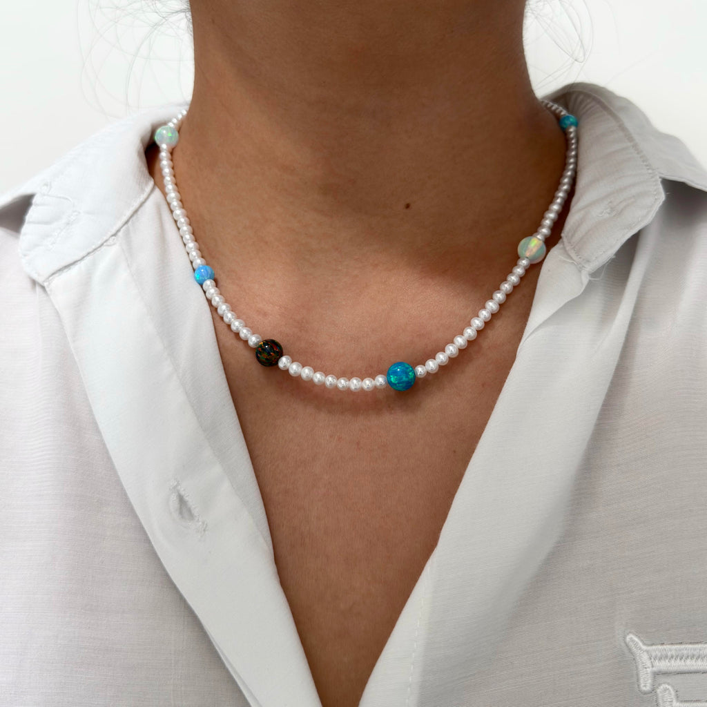 White pearl necklace highlighted by colourful blue and multicolour opals.