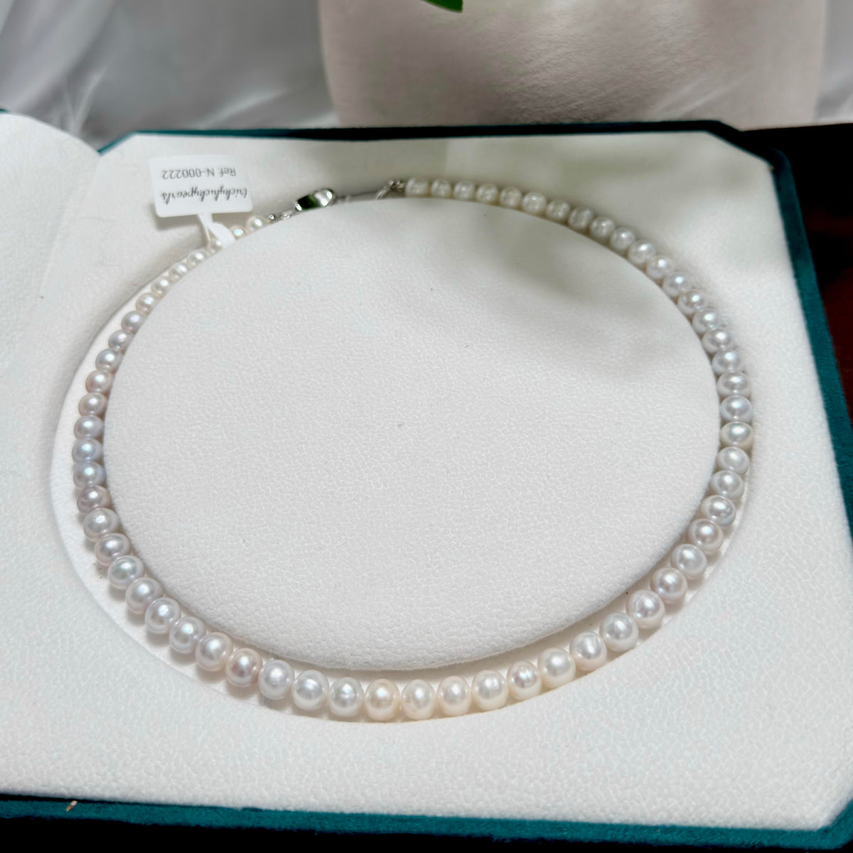 Freshwater pearls showing soft blue iridescence under changing light.