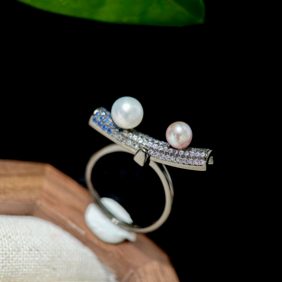 Adjustable sterling silver kinetic pearl ring with movable balance design.