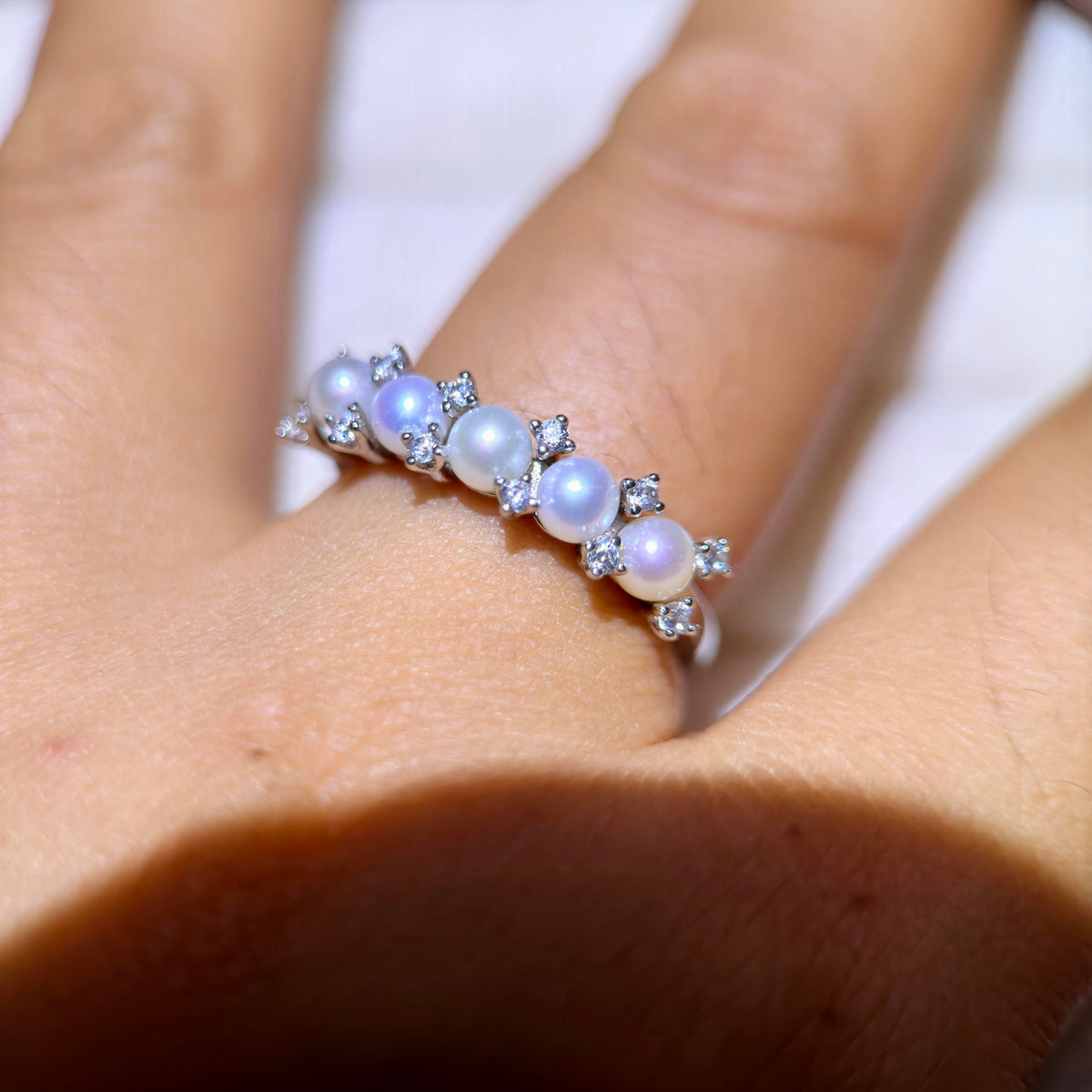 Adjustable sterling silver pearl crown ring with sparkling accents.