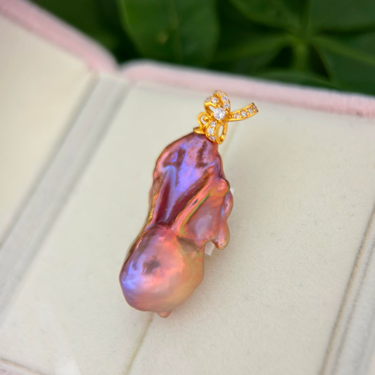 Freshwater pearl jewelry featuring multicolor baroque pearl pendant with sculptural iris flower in sterling silver.
