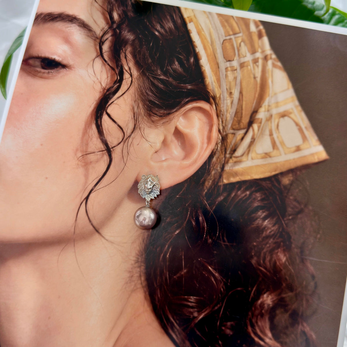 Model wearing large freshwater pearl drop earrings.