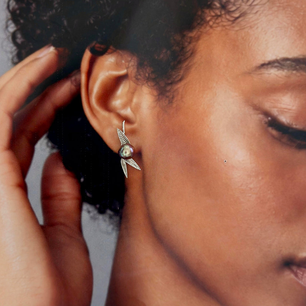 Baroque pearl earrings with a symbolic bamboo design.