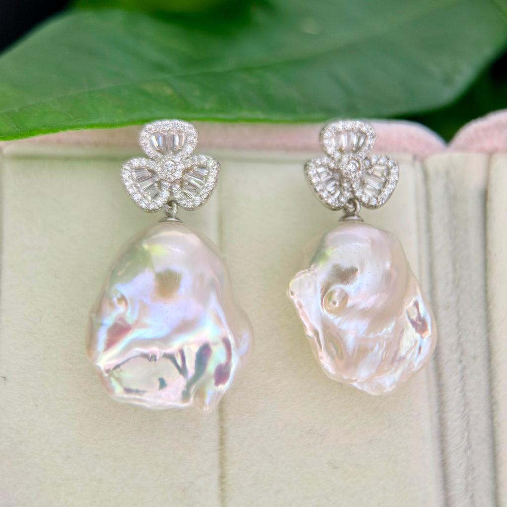Lucky charm pearl earrings with sparkling cubic zirconia details.

