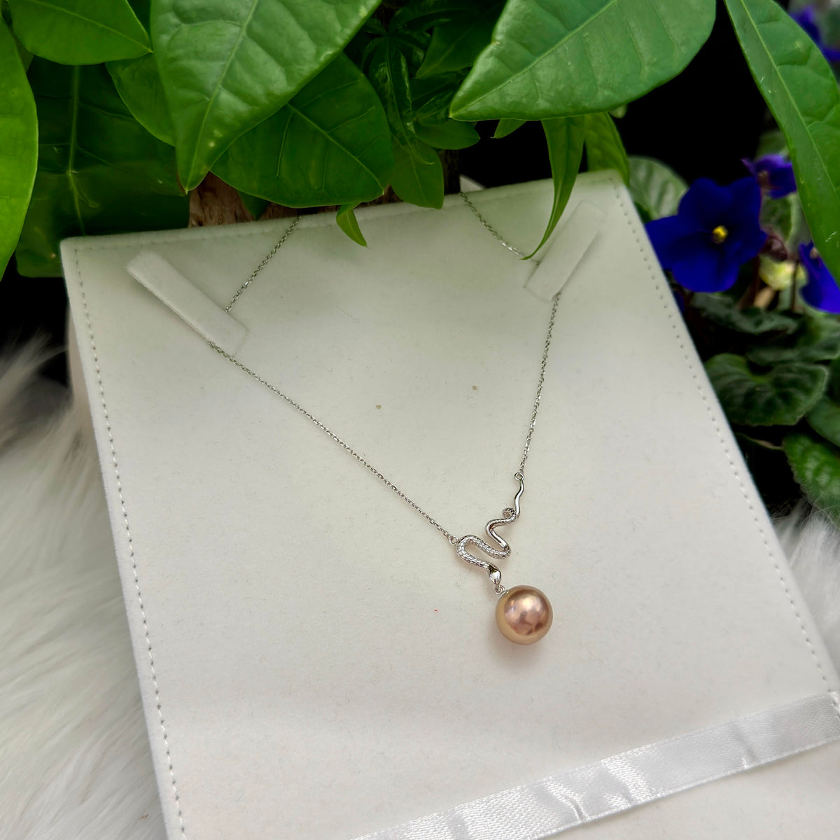 12.3 mm pearl necklace showing changing colours under different light.