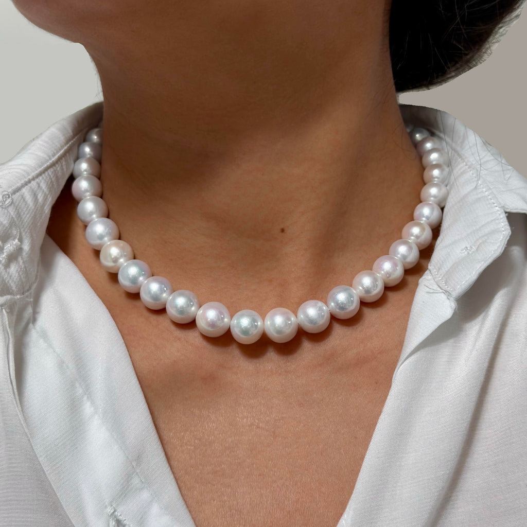 Close-up of 10–12 mm white with soft pink halo freshwater pearl necklace, 42 cm long.