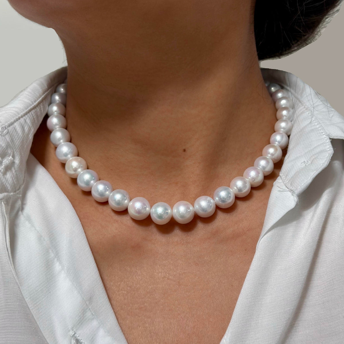 Close-up of 10–12 mm white with soft pink halo freshwater pearl necklace, 42 cm long.