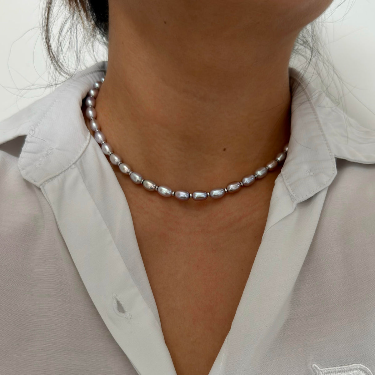Freshwater pearl strand featuring vivid multicolor halo reflections.