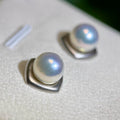 Mirror-luster pearl earrings displaying a cool blue halo.