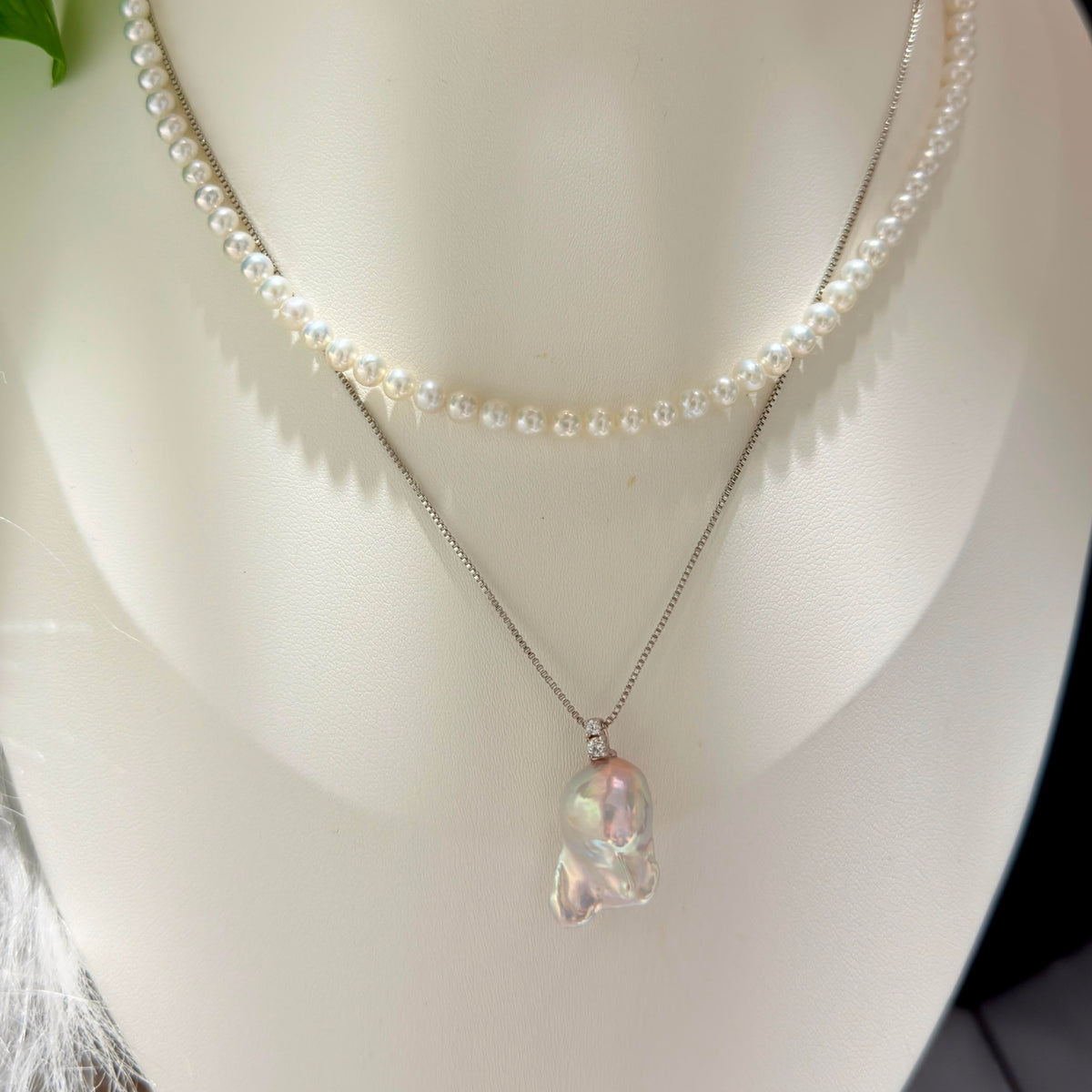 Blue halo pearl pendant with a dreamy iridescent appearance.
