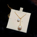 Close-up of flawless mirror-lustre 12 mm golden and 8 mm white pearls.