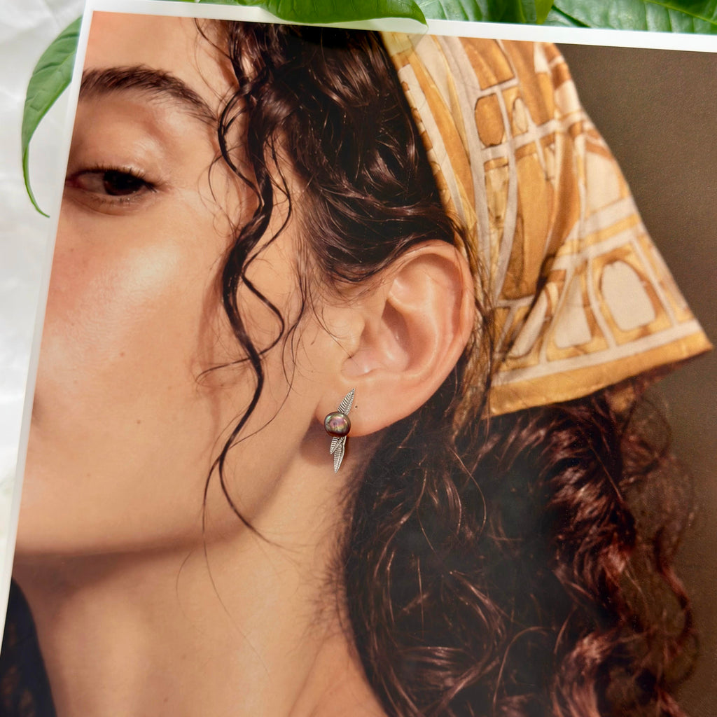 Model wearing nature-inspired pearl stud earrings.