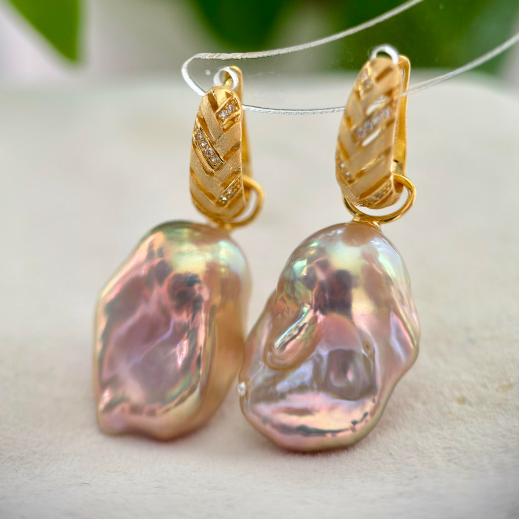 Golden-green baroque pearl earrings with blue and pink iridescent halos.