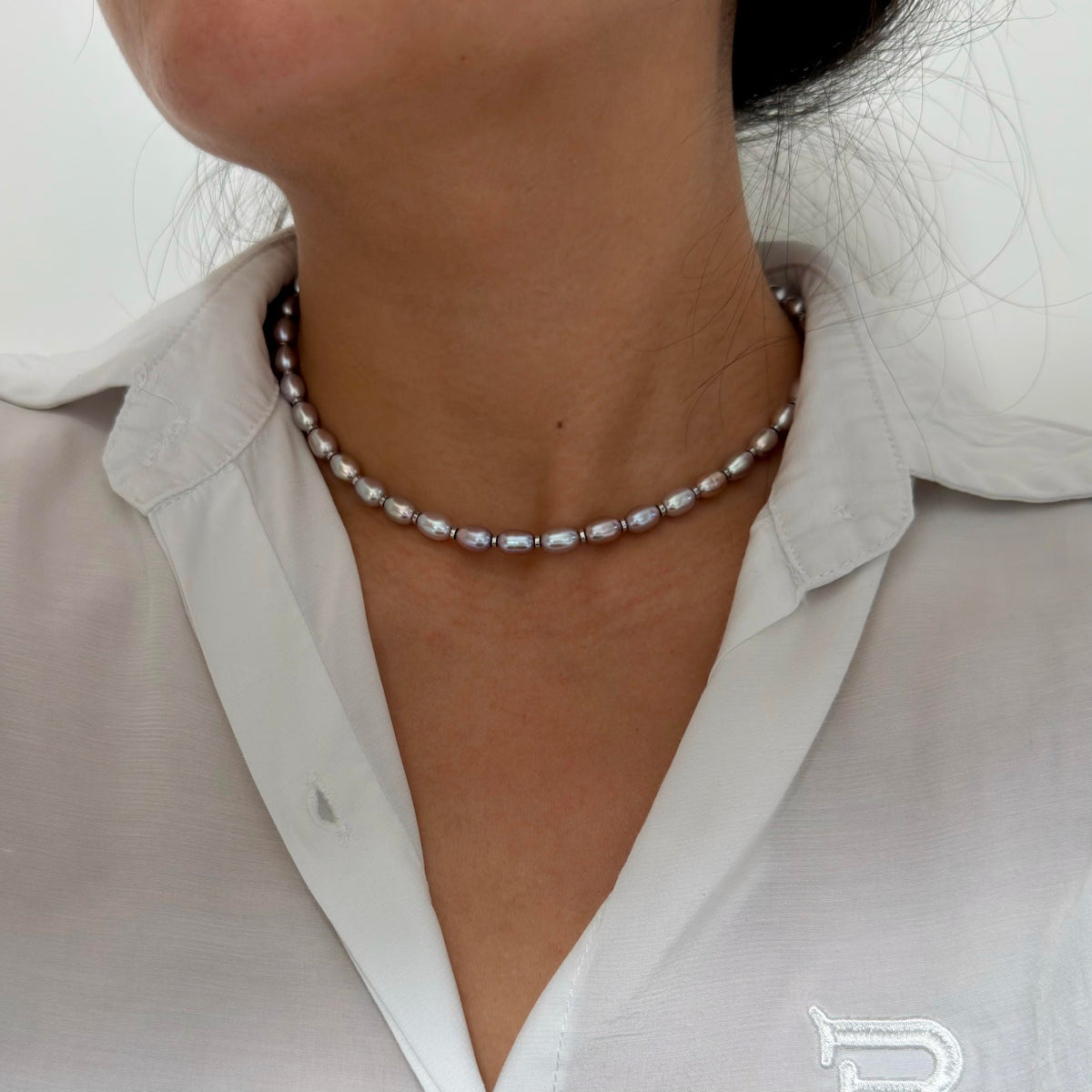 Model wearing a modern oval freshwater pearl necklace.