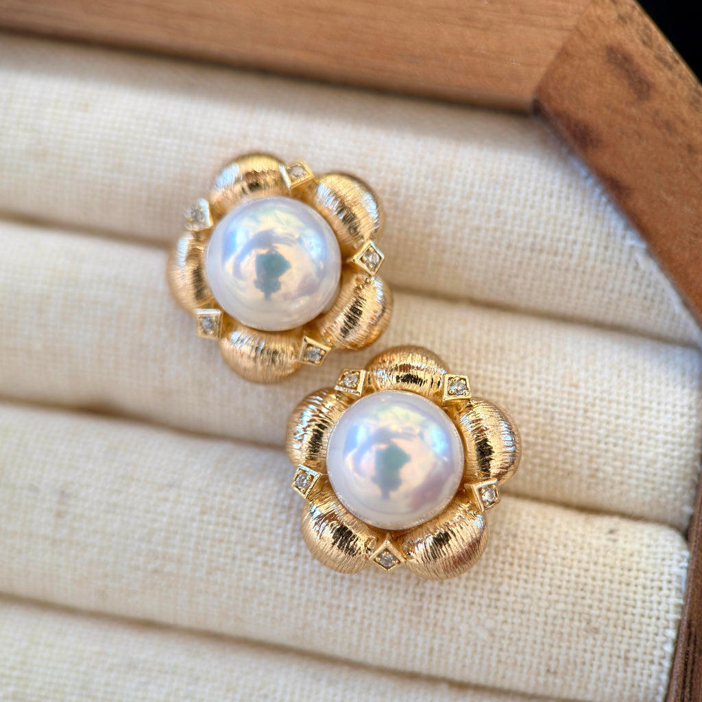 White pearl earrings with soft blue and pink iridescent overtones.