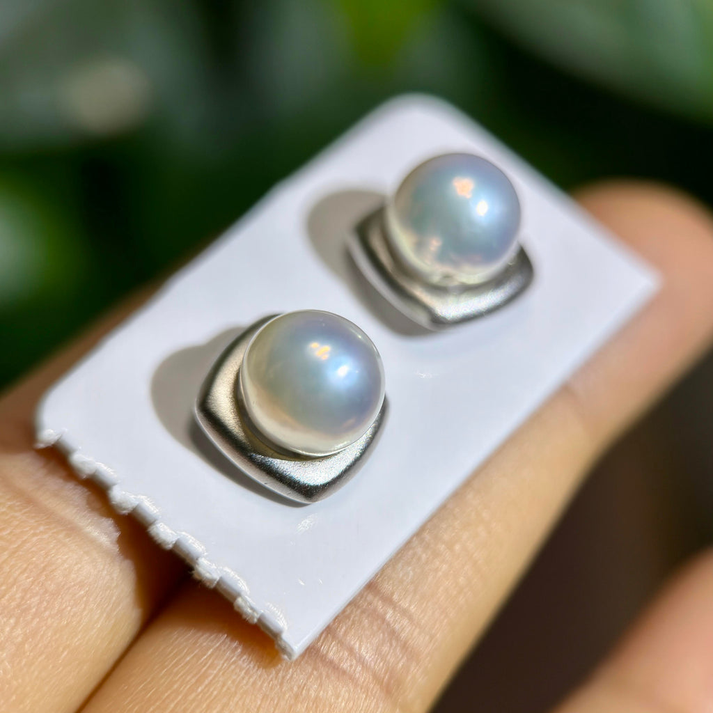 Modern pearl stud earrings with a matte silver finish.