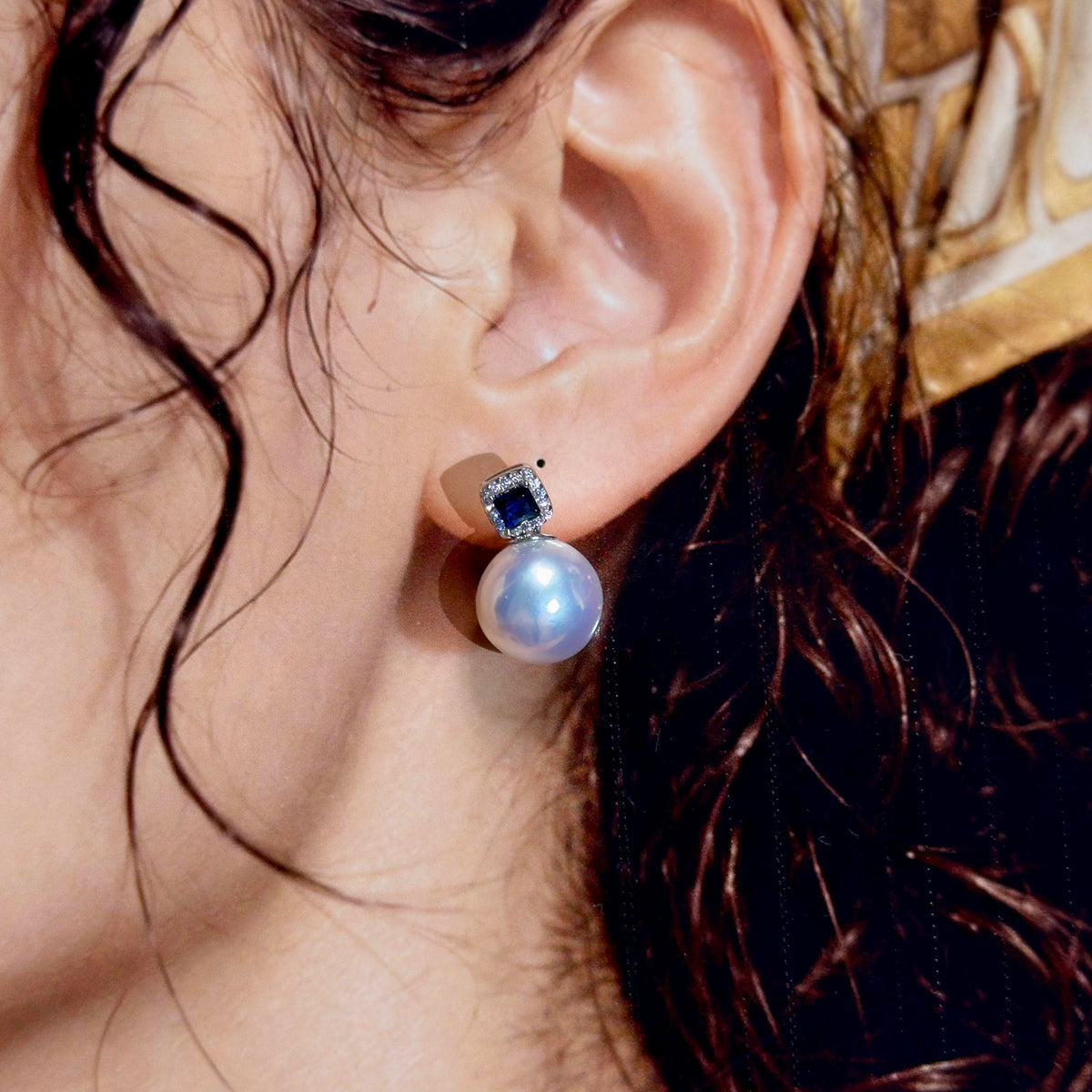 High-lustre white freshwater pearl earrings with elegant blue details.
