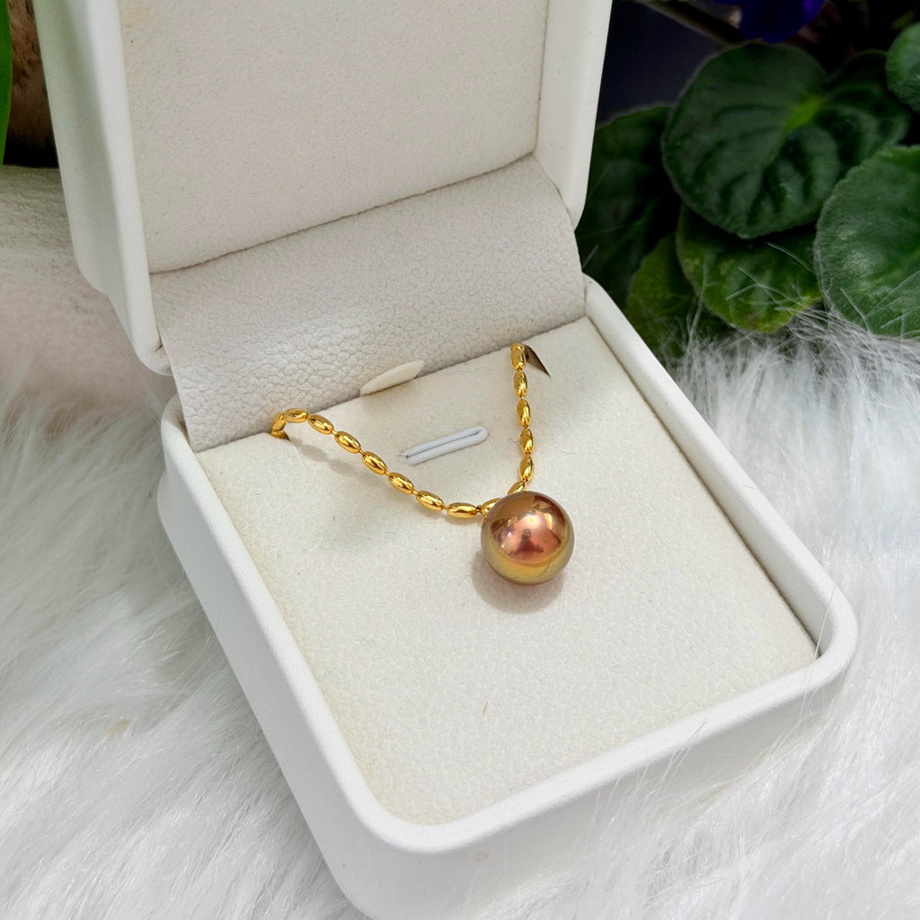 Sterling silver necklace with a natural green and golden freshwater pearl.