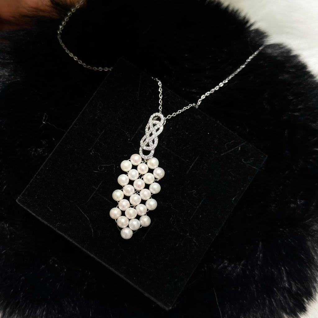 Woven pearl pendant necklace with luminous 4.5 mm white freshwater pearls.