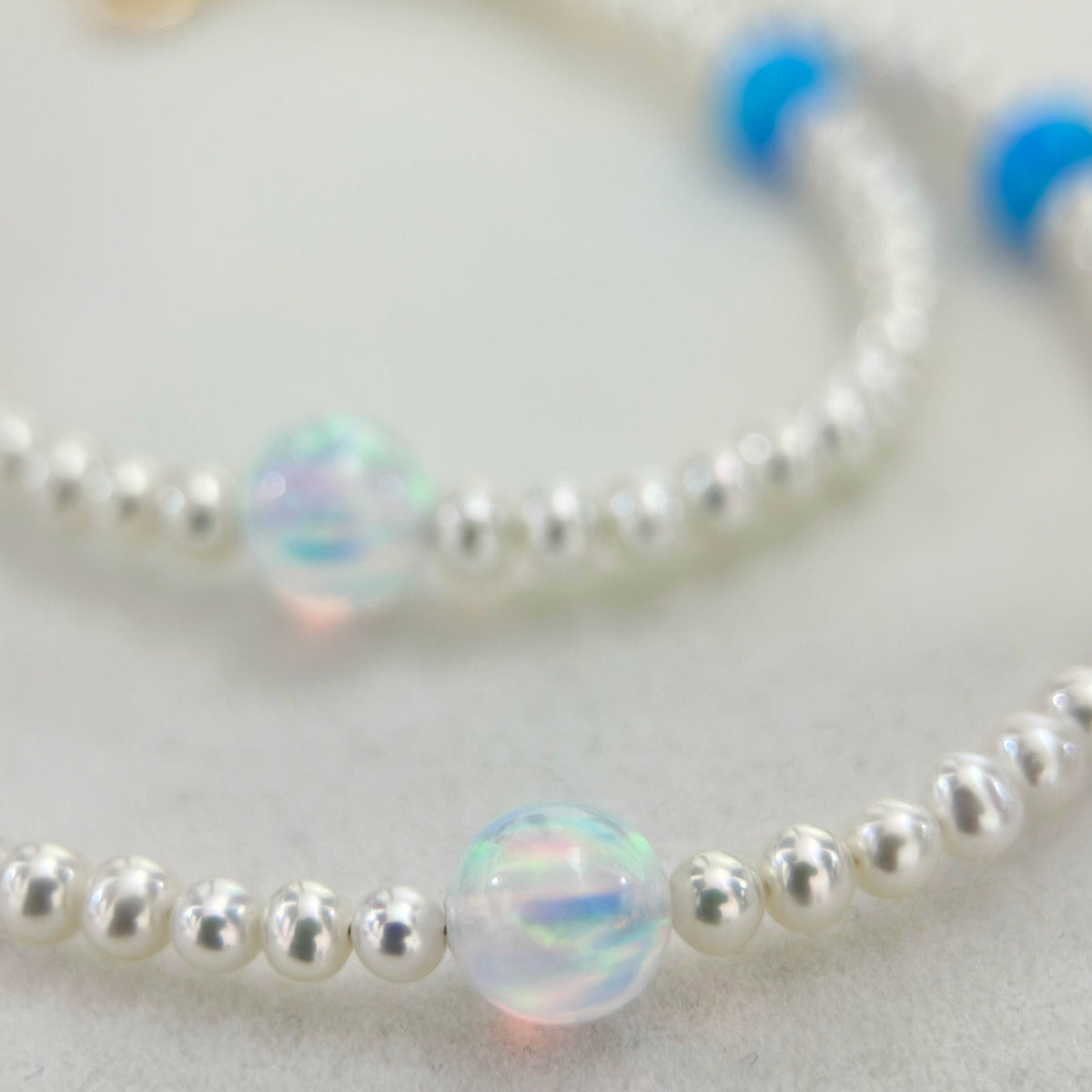 Close-up of water opal and white freshwater pearls in the celestial necklace.
