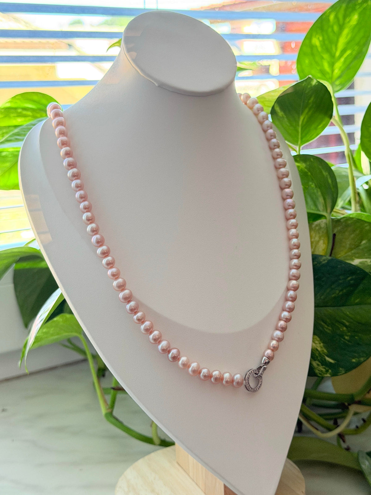 High-lustre pink and purple freshwater pearls in a long necklace.