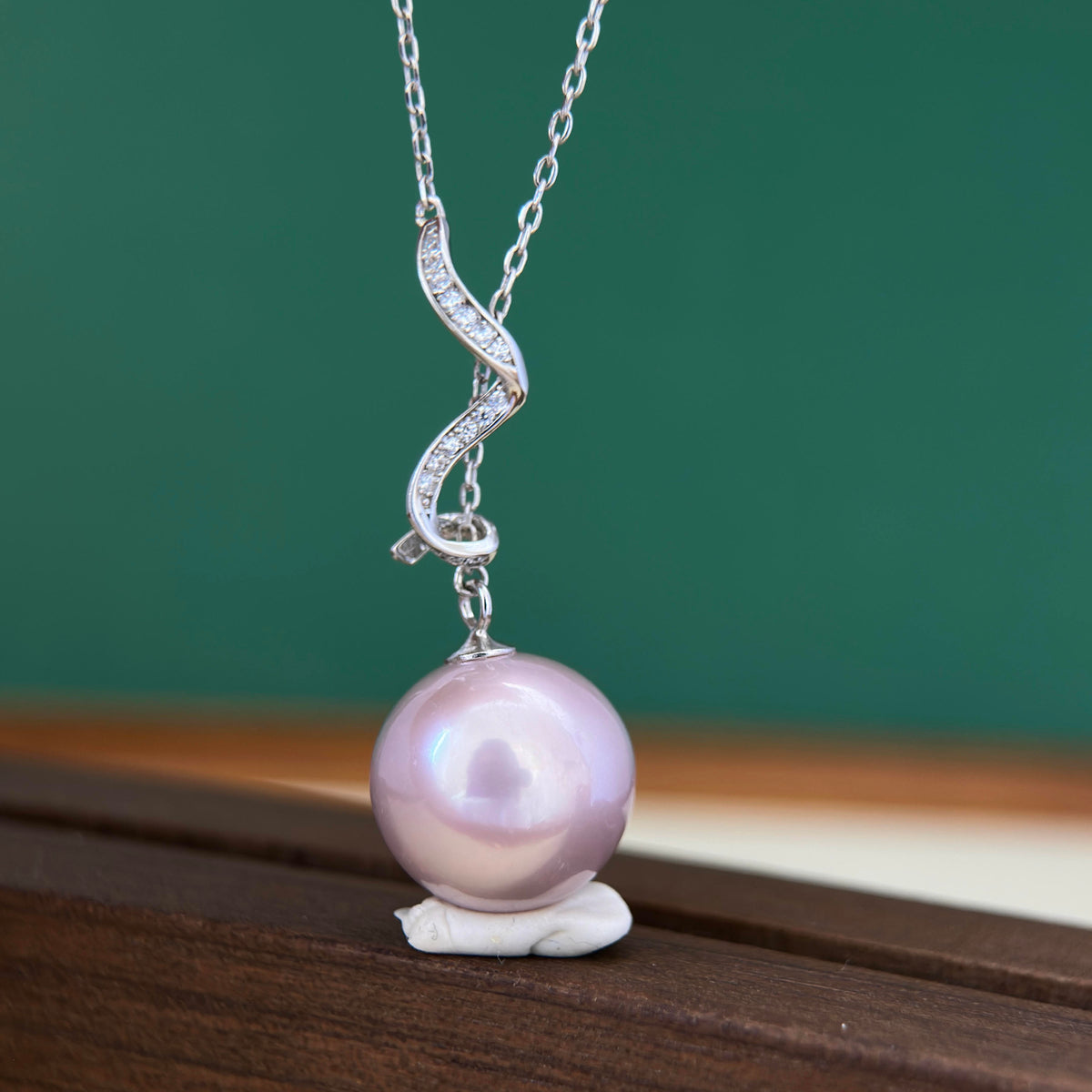 Lavender pearl pendant necklace with sparkling cubic zirconia accents.