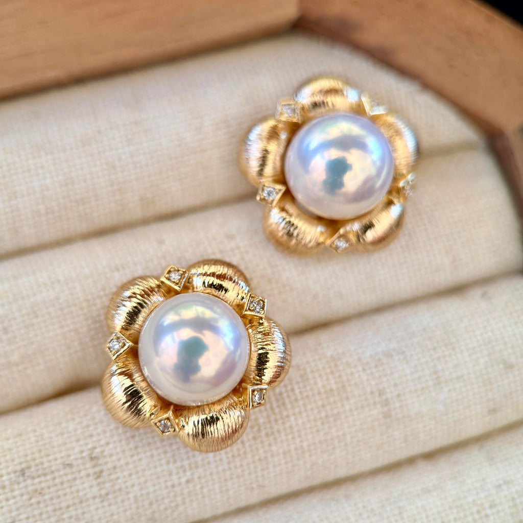 10 mm freshwater pearls framed by vintage floral settings.