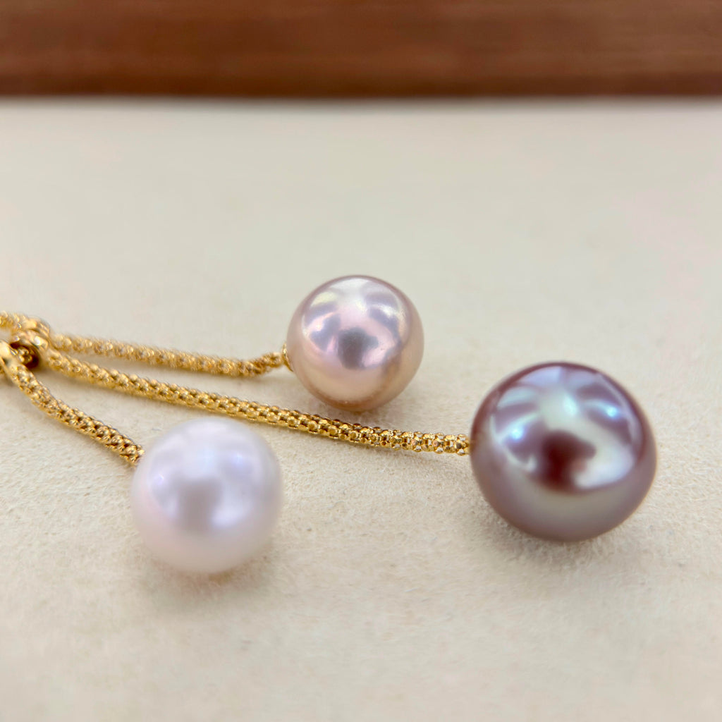 11.4 mm pink freshwater pearl displaying a soft green iridescent halo.