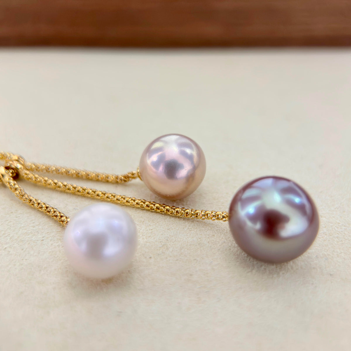 11.4 mm pink freshwater pearl displaying a soft green iridescent halo.
