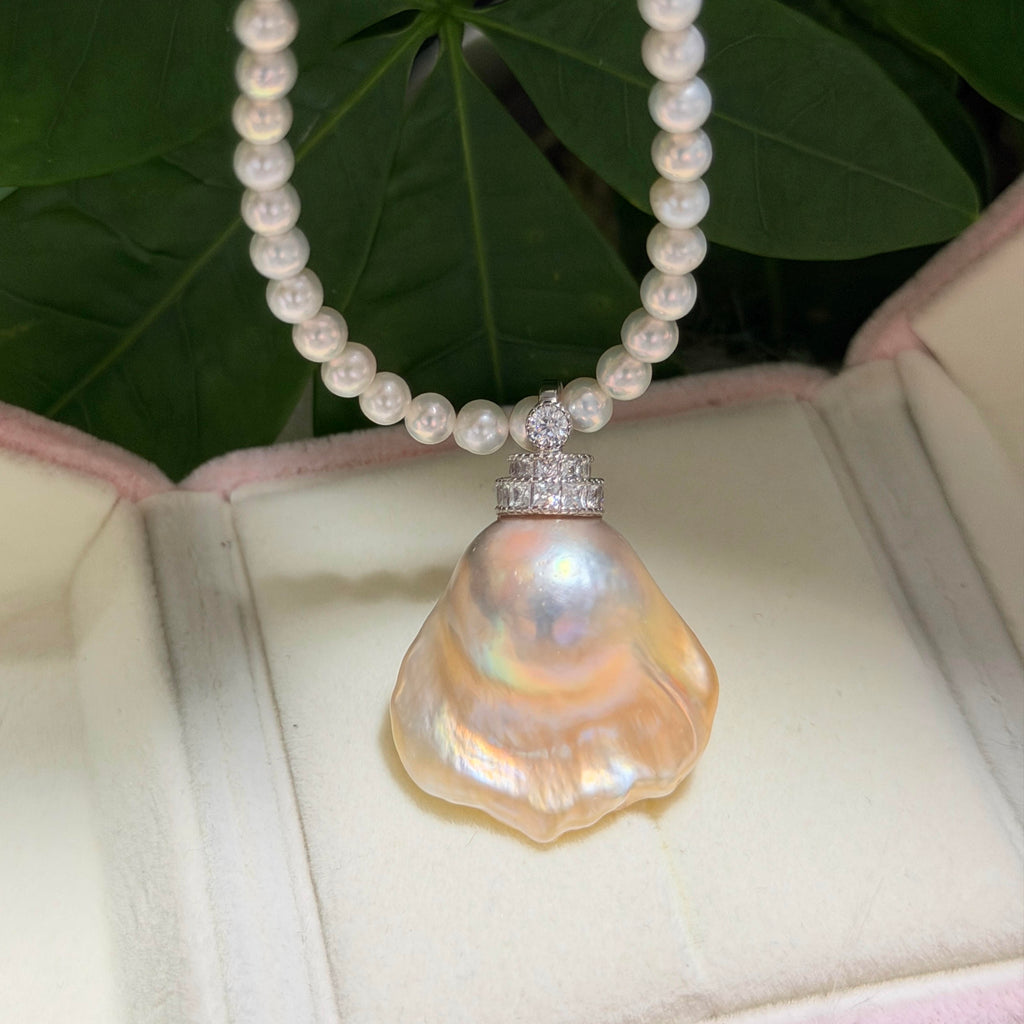 Golden-blue baroque freshwater pearl pendant with light golden halo and universal sterling silver bail.
