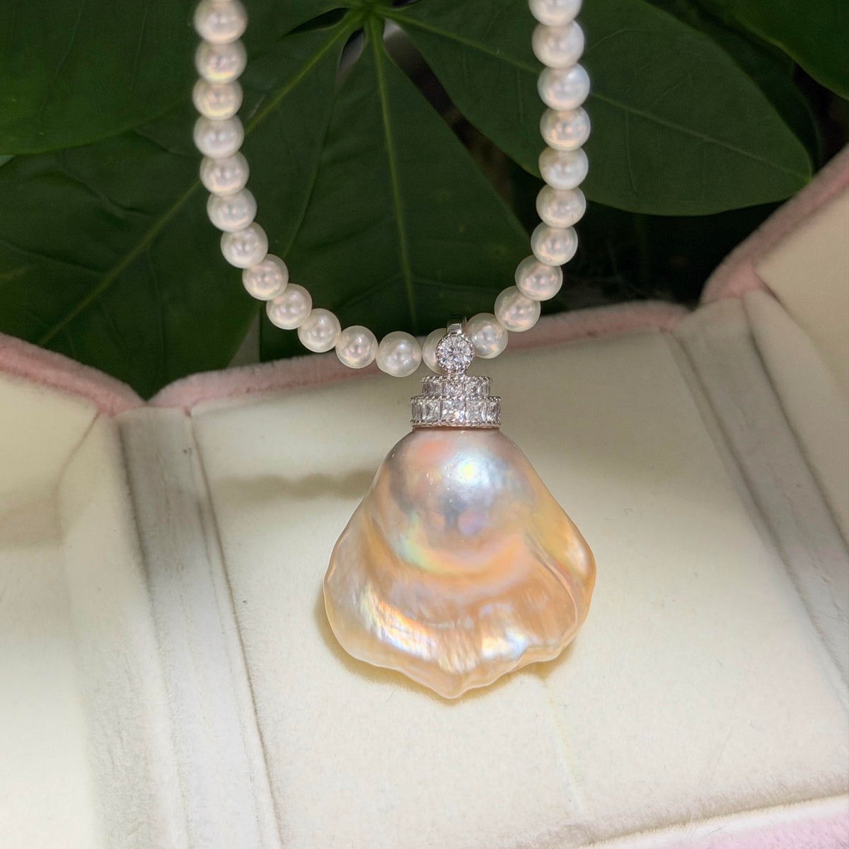 Golden-blue baroque freshwater pearl pendant with light golden halo and universal sterling silver bail.
