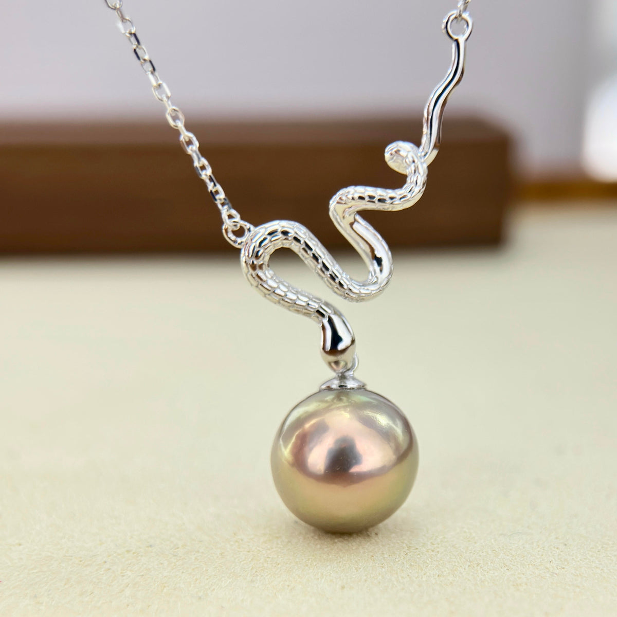 Close-up of a 12.3 mm colour-shifting freshwater pearl on a snake necklace.
