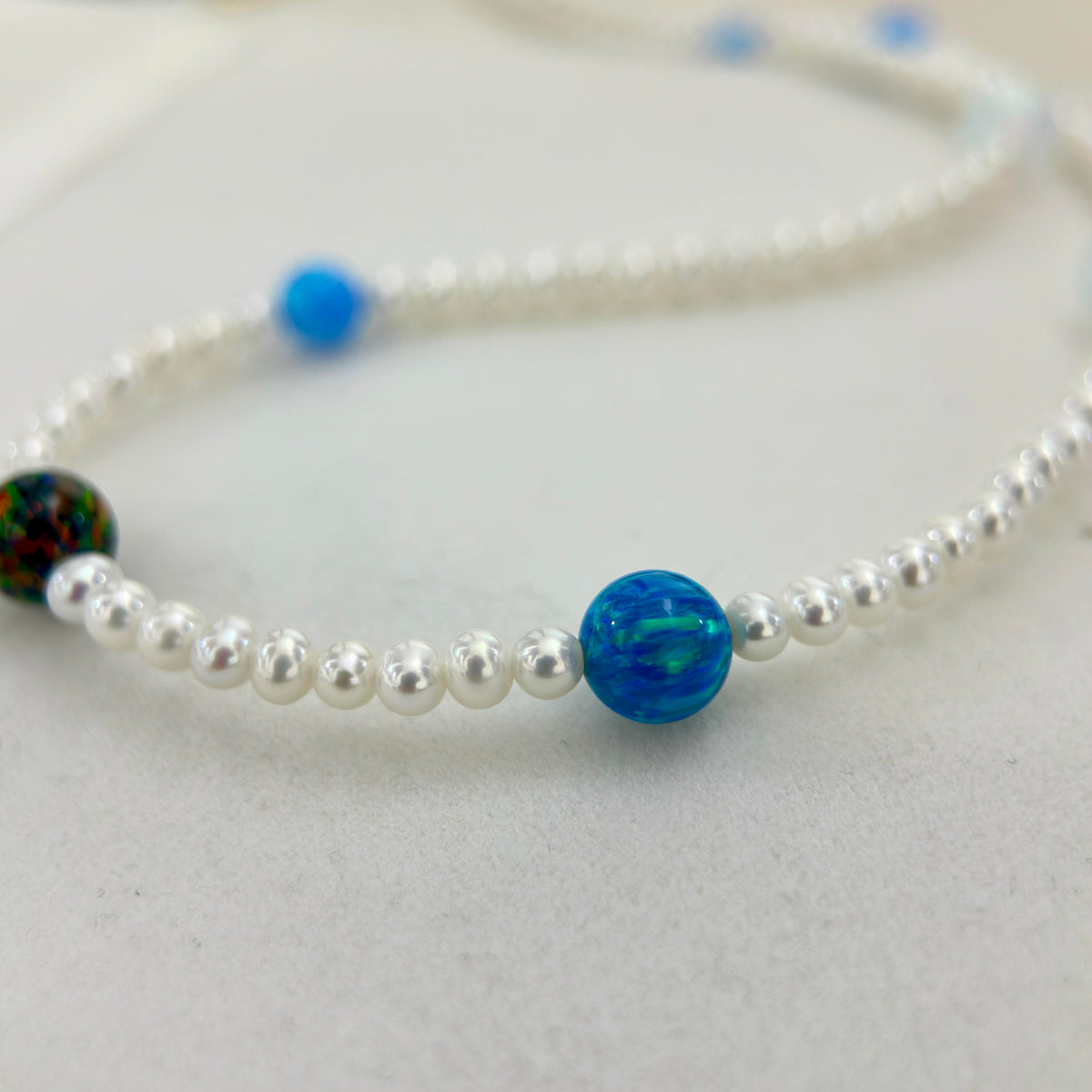 Mixed opal freshwater pearl necklace with a modern celestial design.
