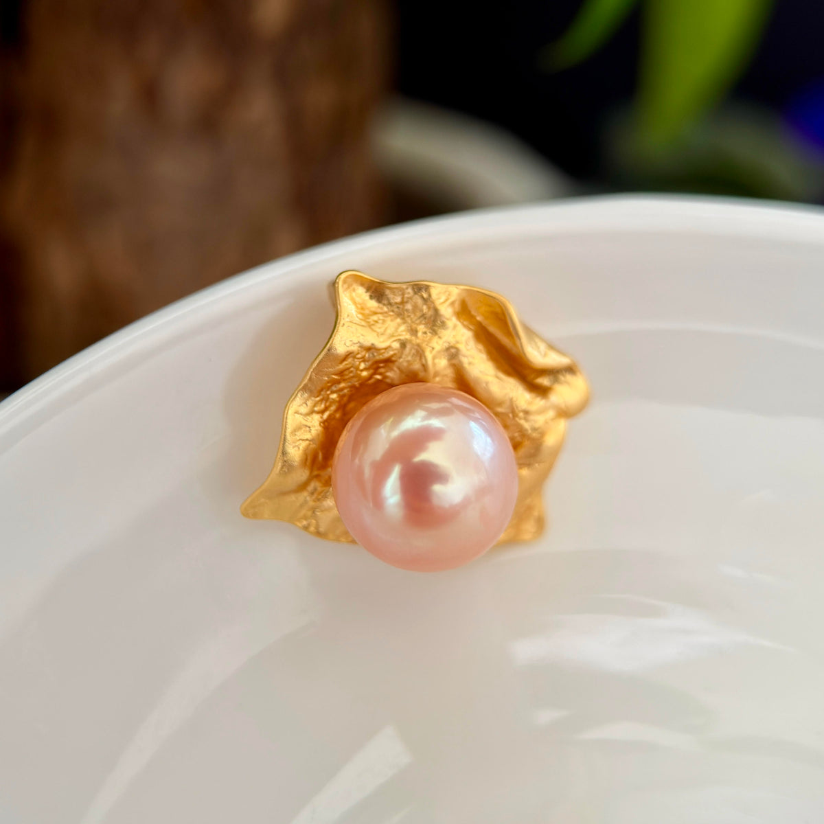 Golden freshwater pearl pendant styled for a creative dinner look.