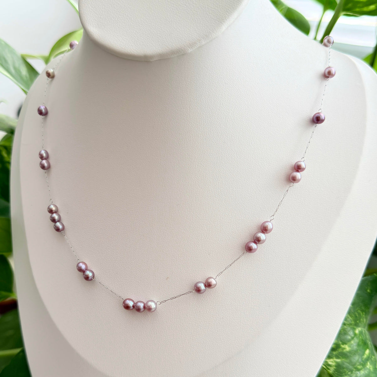 Delicate spaced pearl necklace creating a light floating effect.