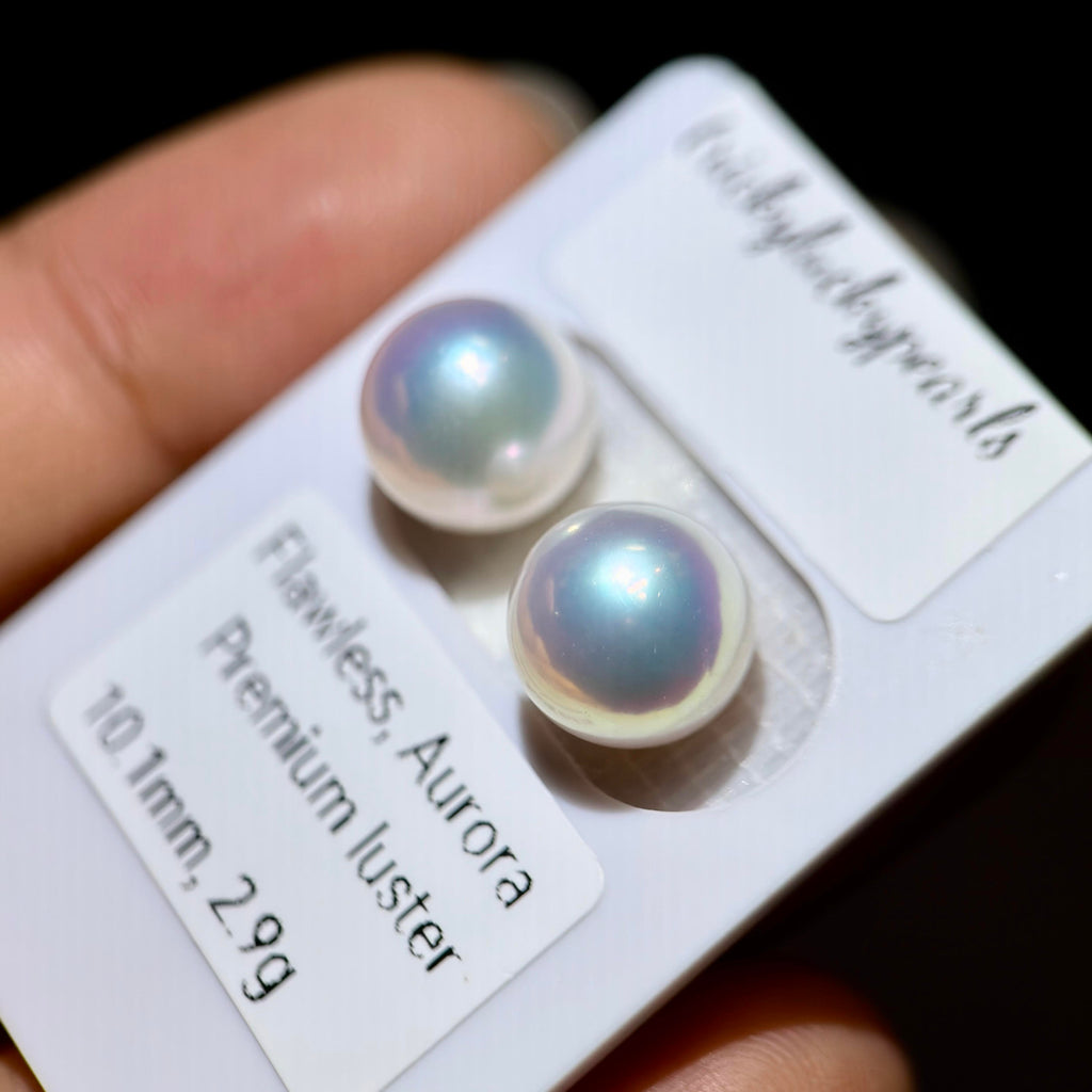 Two round freshwater pearls on a white display card labeled 'Luckyjellypearls' and 'Flawless, Aurora Premium luster 10.1mm, 2.