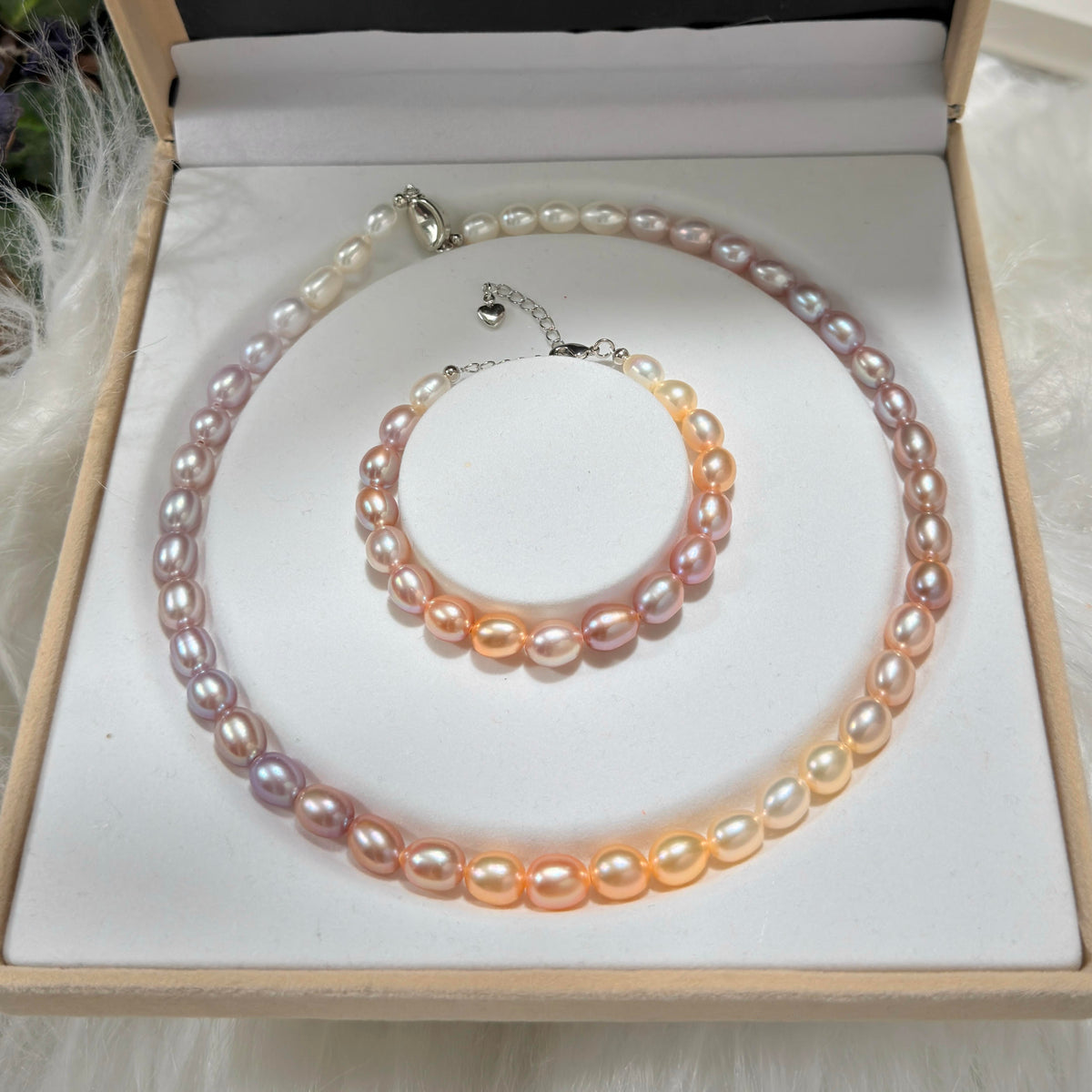 Romantic gradient pearl necklace and bracelet featuring warm and cool natural tones.