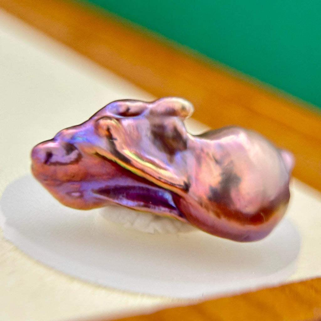Iridescent halo detail on multicolor baroque freshwater pearl pendant with sculptural iris flower in sterling silver.