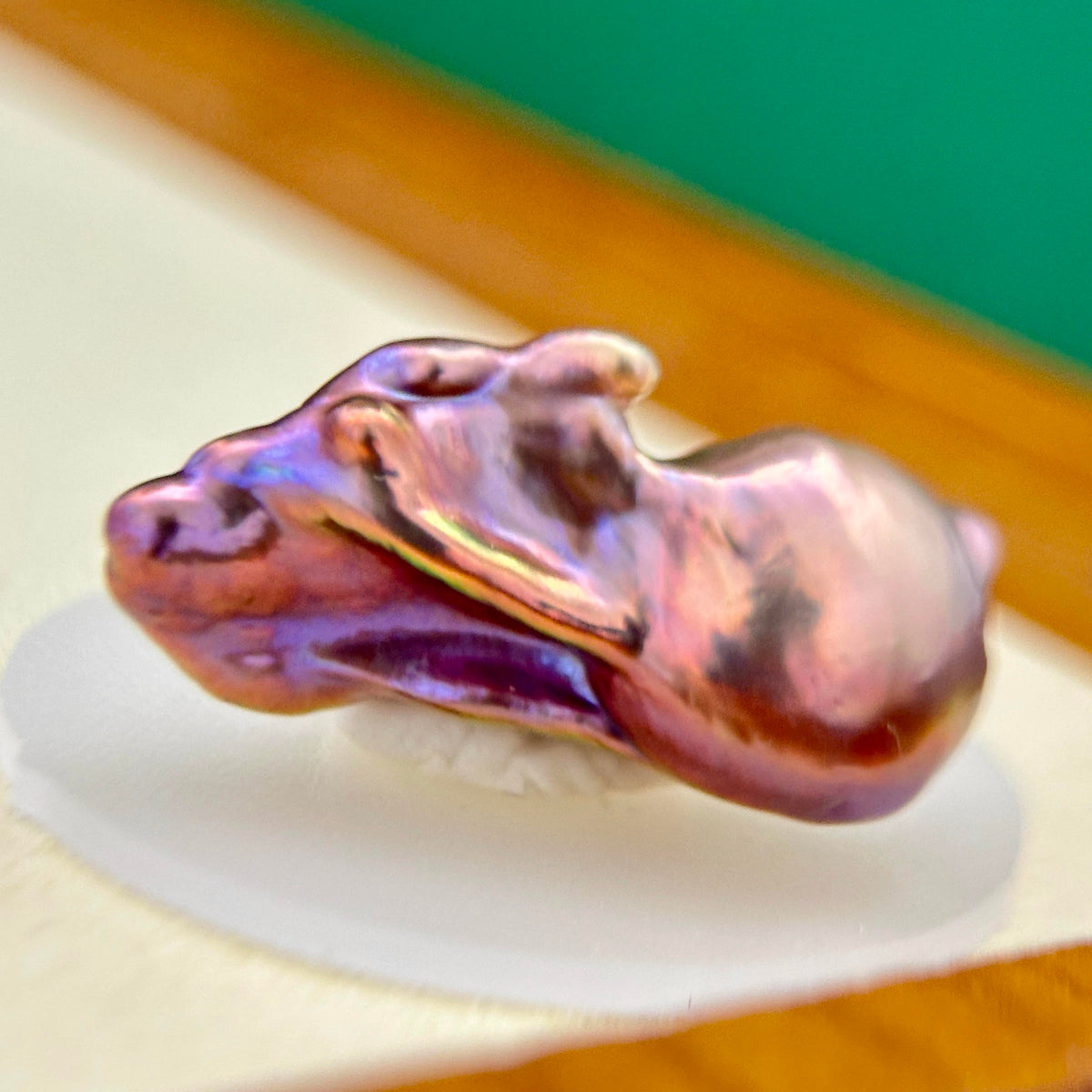 Iridescent halo detail on multicolor baroque freshwater pearl pendant with sculptural iris flower in sterling silver.