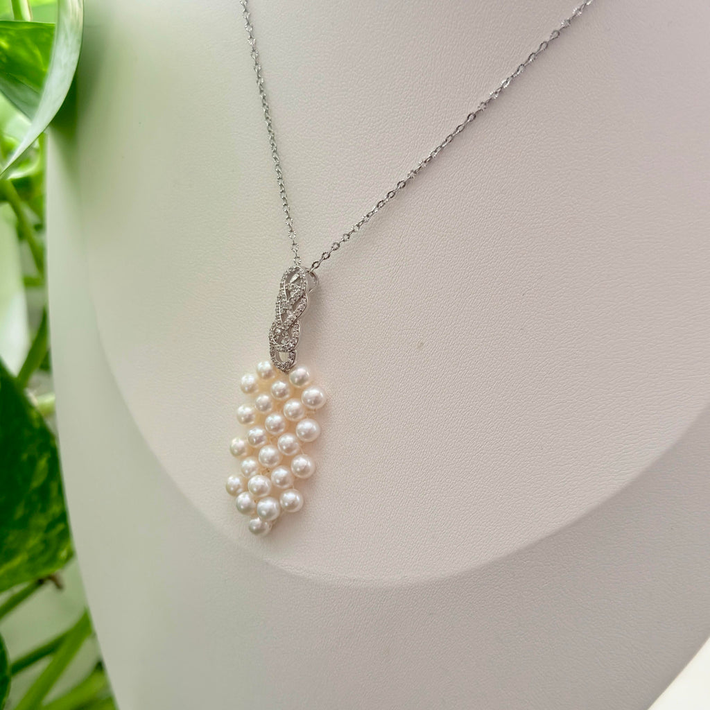 Sterling silver woven pearl necklace with refined feminine styling.
