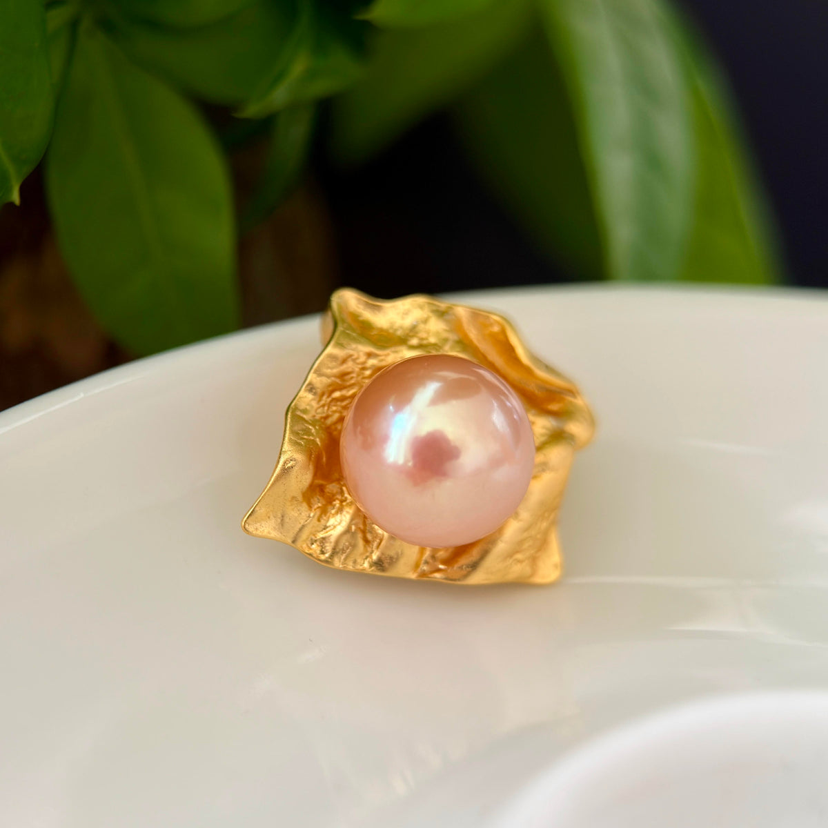 Golden freshwater pearl pendant styled for a creative dinner look.