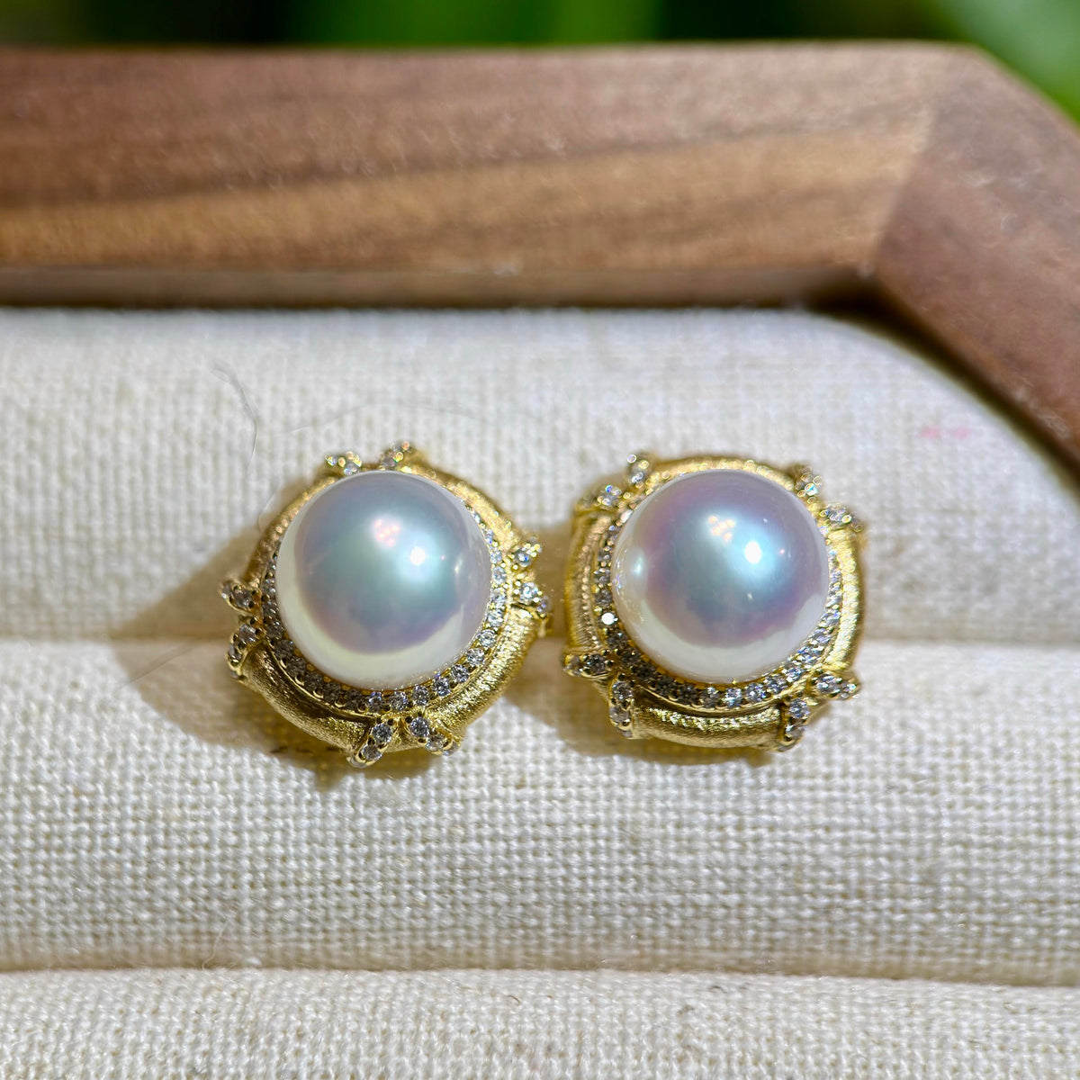 Mirror-lustre white pearl studs with vintage gold setting.
