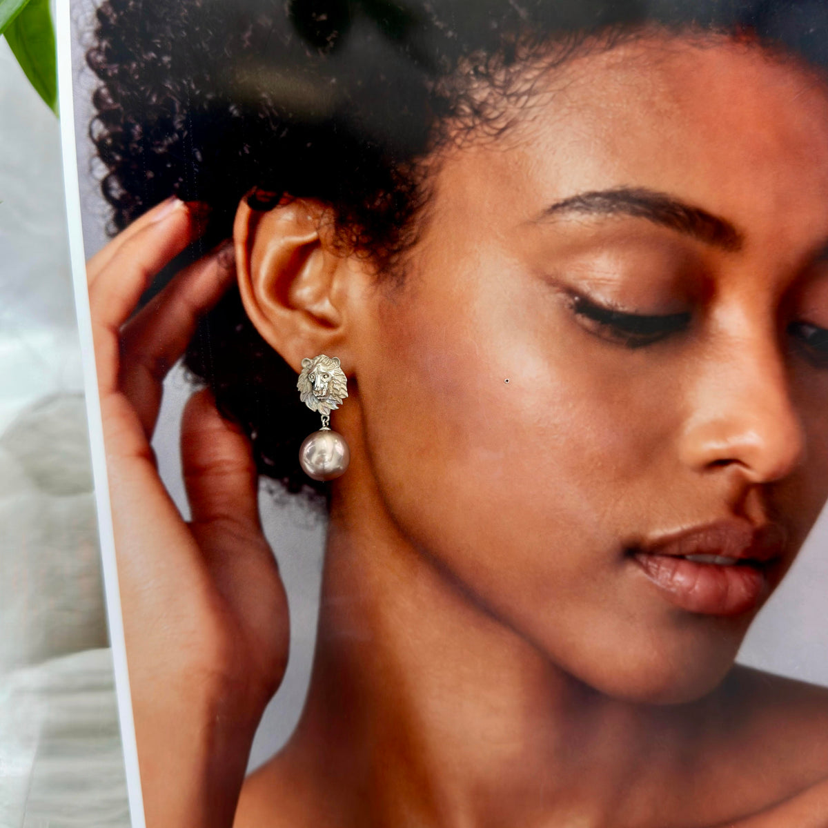 Vintage-inspired lion pearl earrings with a dramatic drop silhouette.