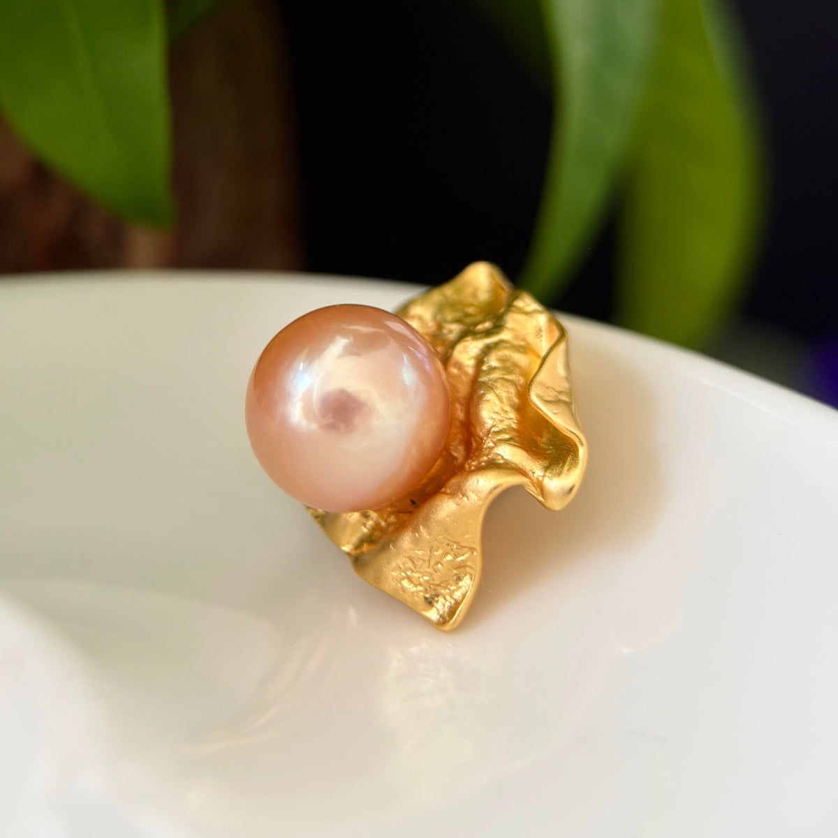 Unique wrinkled-paper pearl pendant designed as wearable art.