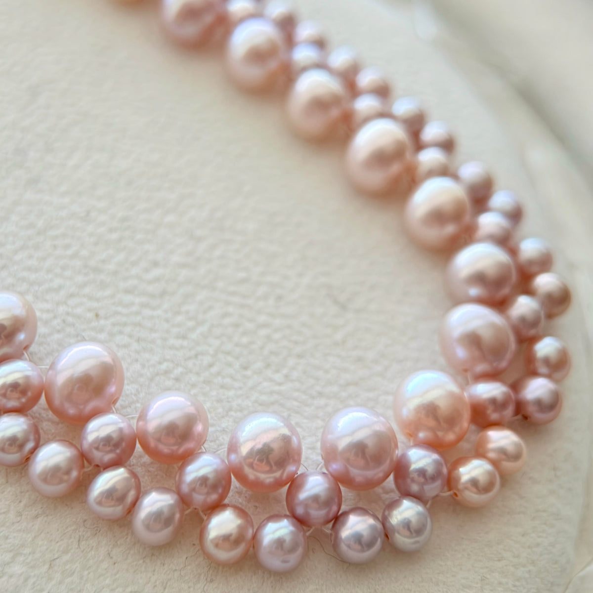 Close-up of the statement pearl choker with exceptionally bright pearls.