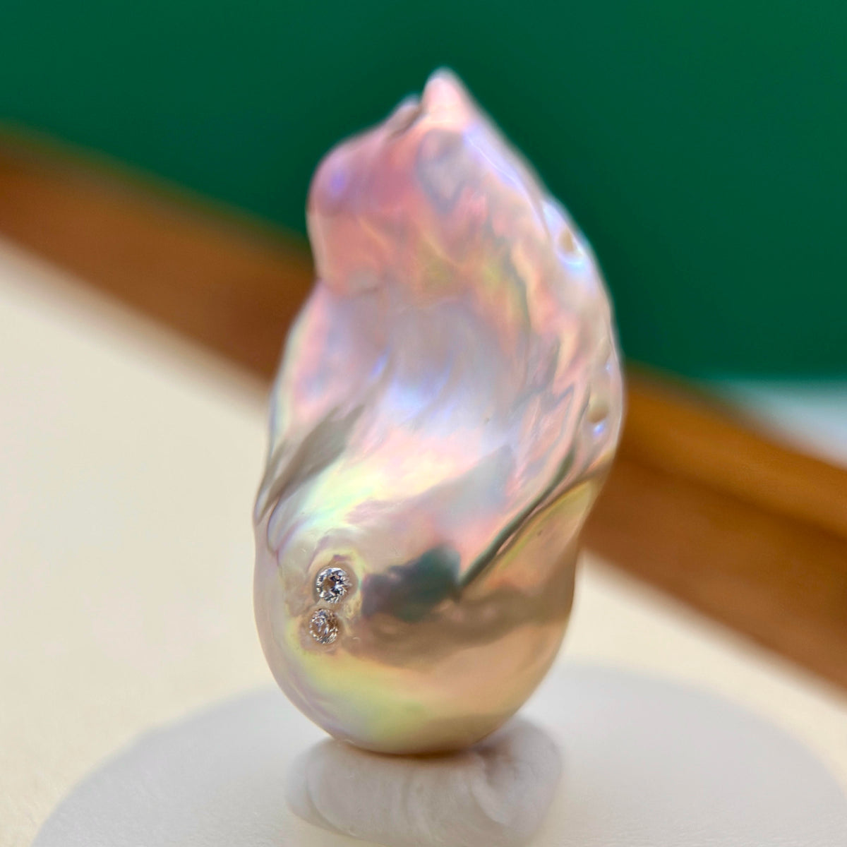 Freshwater pearl jewelry featuring golden-green baroque pearl pendant with sculptural osmanthus flower in sterling silver.
